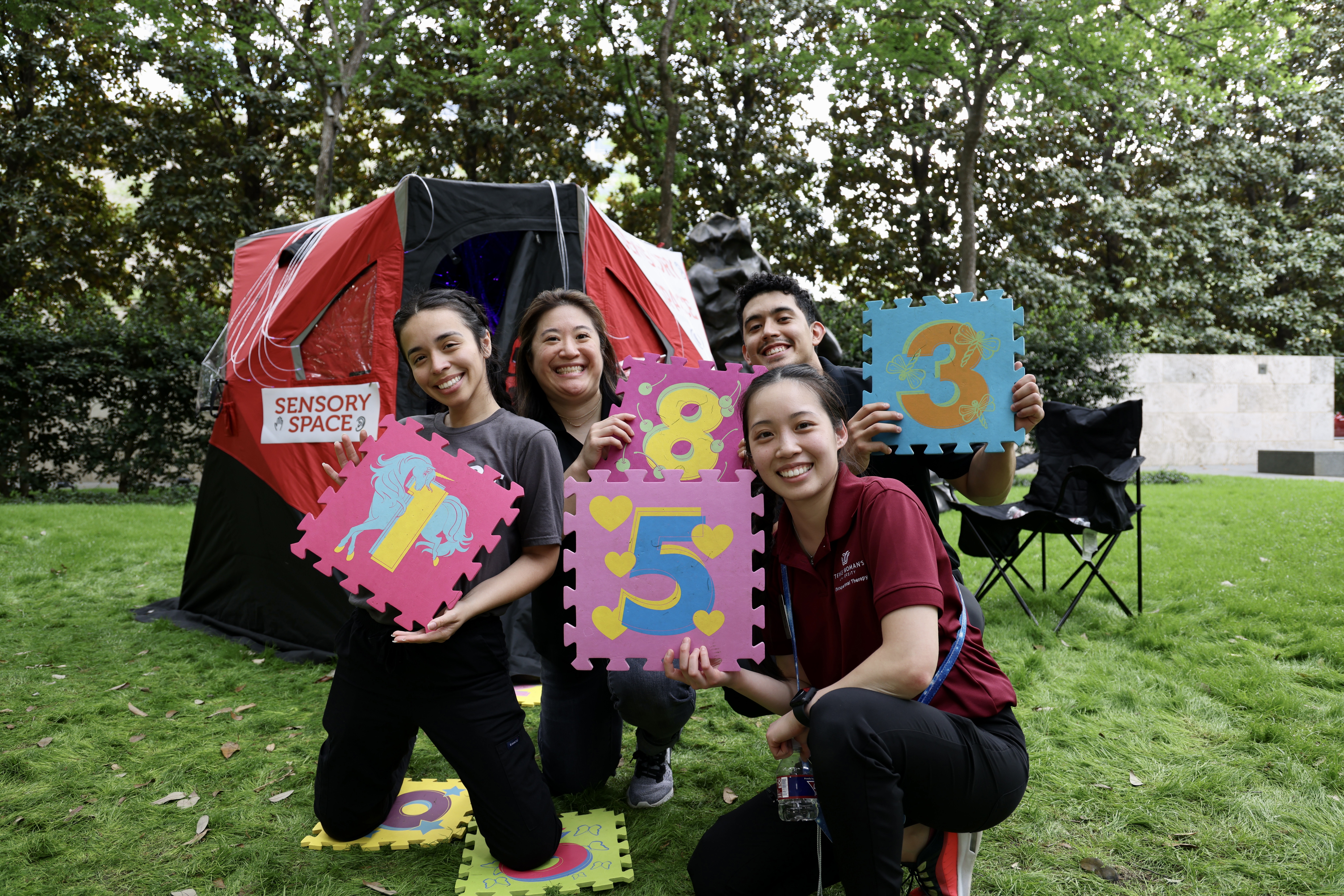 Four Student holding number puzzle pieces